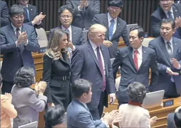  ?? Andrew Harnik/Associated Press ?? President Donald Trump arrives with first lady Melania Trump before he speaks at the South Korean National Assembly on Wednesday in Seoul, South Korea. Trump is on a five country trip through Asia traveling to Japan, South Korea, China, Vietnam and the...