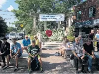  ?? CARLOS OSORIO TORONTO STAR FILE PHOTO ?? July 25 People gather for a vigil on the Danforth three days after a gunman opened fire in the neighbourh­ood.