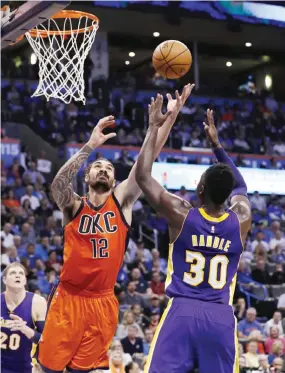  ??  ?? OKLAHOMA CITY: Oklahoma City Thunder center Steven Adams (12) and Los Angeles Lakers forward Julius Randle (30) go up for a loose ball during the second half of an NBA basketball game in Oklahoma City, Sunday. Oklahoma City won 113-96. — AP