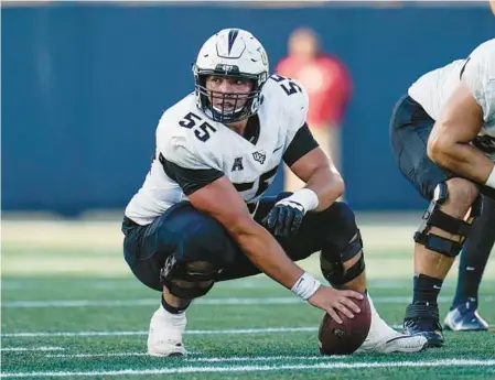  ?? JULIO CORTEZ/AP ?? UCF center Matthew Lee prepares to snap the ball against Navy on Oct. 2, 2021, in Annapolis, Maryland. Lee announced he will transfer to Miami on Sunday.