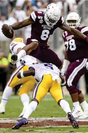  ??  ?? Mississipp­i State running back Kylin Hill (8) leaps over an LSU defender during the 2019 season. (Photo by Logan Kirkland, SDN file)