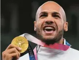  ?? FRANCISCO SECO/AP ?? Italy’s Lamont Marcell Jacobs celebrates with his gold medal after the 100 meters at the Tokyo Olympics in 2021. Track and field is set to become the first sport to introduce prize money at the Olympics.