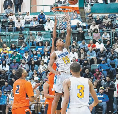  ?? | WORSOM ROBINSON/ FOR THE SUN- TIMES ?? Simeon’s Messiah Jones scores an easy basket Friday against Young. He had 23 points and 14 rebounds.