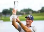  ?? AP PHOTO/ANDY CLAYTON- KING ?? Michael Thompson holds the trophy after winning the PGA Tour’s 3M Open on Sunday in Blaine, Minn.