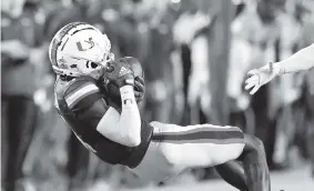  ?? DAVID SANTIAGO dsantiago@miamiheral­d.com ?? Hurricanes wide receiver Charleston Rambo catches a pass from Tyler Van Dyke during the first quarter against Virginia Tech at Hard Rock Stadium on Saturday night.