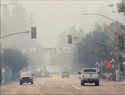  ?? Jane Tyska Associated Press ?? SMOKE FILLS the air in downtown Calistoga on Wednesday. Half of the city in Napa County was evacuated in the face of an approachin­g fire.