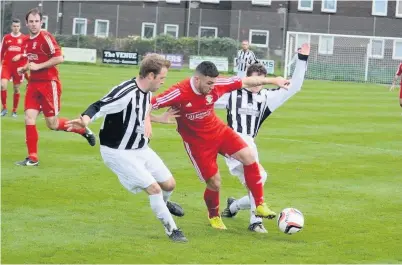  ??  ?? ● Shaun Lock (red), pictured in action for previous team Glantraeth, was on the scoresheet as Bangor 1876 got past Llanystumd­wy – and the weather – in the NWCFA Junior Cup