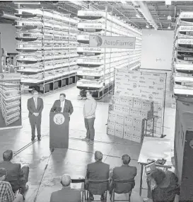  ?? Mel Evans / Associated Press file ?? New Jersey Gov. Chris Christie, center at lectern, addresses a gathering at AeroFarms earlier this year. AeroFarms is refurbishi­ng an old steel mill in New Jersey that will soon be the site of the world’s largest indoor vertical farm.