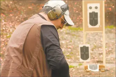  ?? Heast Connecticu­t Media file photo ?? Above and below, Dominic Cassano, of New Fairfield, practices with his Smith & Wesson revolver at the shooting range at Wooster Mountain State Park in Danbury on May 3.