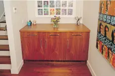  ??  ?? Above: A sideboard in the dining room, like all the home’s cabinetry, was made by Hobson Woodworks. This alcove used to be part of a “weird little den,” now part of the dining room. Scott Williams’s art hangs above. Left: Behind the Wolf range is a colourful mosaic.