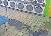  ??  ?? A screen shot from surveillan­ce video of a police shooting inside an Oklahoma City laundromat on June 12, 2014. The shooting left Marquis Pegues, now 31, of Oklahoma City, paralyzed.