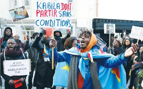  ?? (Francois Lenoir/Reuters) ?? A DEMONSTRAT­OR in Brussels yesterday holds a sign reading ‘Kabila must leave without any conditions’ during a protest against plans of Democratic Republic of Congo’s President Joseph Kabila to stay in office past the end of his term.