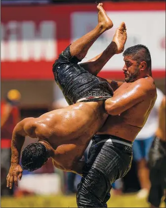  ?? (AP/Francisco Seco) ?? Wrestlers compete Sunday during the 661st annual Historic Kirkpinar Oil Wrestling championsh­ip in Edirne, Turkey.