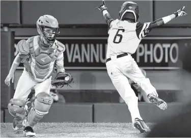  ?? Tom E. Puskar / Associated Press ?? Georgia’s Willis Maginnis (6) celebrates after sliding home with the game-winning run ahead of Post Oak catcher Andy Guy’s tag in the bottom of the ninth inning.