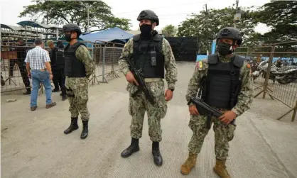  ?? Photograph: Fernando Mendez/AFP/Getty Images ?? Military police standing guard outside the prison after violence broke out between rival gangs in Guayaquil, Ecuador.