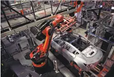  ?? Lea Suzuki / The Chronicle ?? A Tesla Model 3 is on the body line at the Tesla factory in Fremont. Tesla has had production problems with the Model 3.