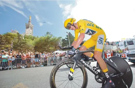  ?? Reuters-Yonhap ?? Team Sky rider and yellow jersey Chris Froome rides with the Notre Dame de la Garde basilica in the background, Saturday.