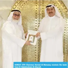  ??  ?? KUWAIT: KFH Chairman Hamad Al-Marzouq receives the book from Dr Abdulmohse­n Al-Kharafi.