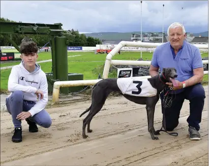  ?? Photo by www.deniswalsh­photograph­y.com ?? Jerry Griffin holding on to race winner Sporting Rita alongside his grandson Adam Murphy who were delighted to be back with their greyhounds and racing at the Kingdom Greyhound Stadium last Friday.