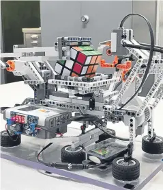  ??  ?? The Rubik’s Cube-solving robot is the brainchild of Abertay University students.