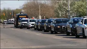  ?? (AP/Paul Sancya) ?? Members of law enforcemen­t agencies drive past St. John Hospital & Medical Center in Detroit on Monday in a procession honoring medical and front-line personal assisting during the coronaviru­s pandemic.