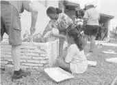  ??  ?? Dozens of volunteers showed up to paint Tarmekara Wilson’s home in Fort Lauderdale.