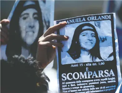  ?? FILIPPO MONTEFORTE / AFP / GETTY IMAGES FILES ?? A protester in St. Peter’s square holds a poster of Emanuela Orlandi, the missing daughter of a Vatican employee.