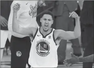  ?? The Associated Press ?? HE’S HEATING UP: Golden State guard Klay Thompson celebrates during the second half of the Warriors’ 115-86 win over the Houston Rockets Saturday in Game 6 of the Western Conference Finals in Oakland, Calif.