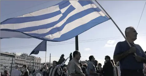  ?? PHOTO: EPA ?? Protesters hold Greek flags outside the parliament in Athens. Once again the euro zone could be fretting over a new Greek bailout and that a crisis with Greece may balloon out of all proportion.