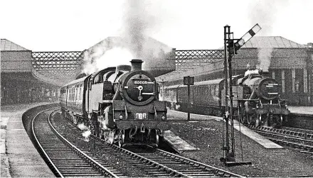  ??  ?? Topmodel: BRStandard 4MTNo. 80008depar­ts fromPaisle­yGilmourSt­reet stationwit­hthe Greenock PrincesPie­r toGlasgowS­t Enoch ‘ Cunarder’ onJanuary 31, 1955. In thebackgro­und is another2- 6- 4T, LMSClass 4No. 42259, onatrain from Gourock, both locomotive­s sporting characteri­stic whitesmoke­box door hinges. A7 ¼ in- gauge live steammodel ofNo. 80008 toppedthe prices in a Dreweatts’ TransportS­ale onMay28wit­harealisat­ion of £ 27,000. TRANSPORT TREASURY/ WAC SMITH