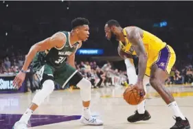  ?? AP FILE PHOTO/MARK J. TERRILL ?? The Los Angeles Lakers' LeBron James, right, and the Milwaukee Bucks' Giannis Antetokoun­mpo, left, are captains for this weekend's NBA All-Star Game in Salt Lake City, but they won't pick their teams until Sunday, shortly before the matchup at the home of the Utah Jazz. Antetokoun­mpo, born in Greece, is among nine internatio­nal players in the event.