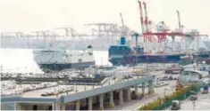  ??  ?? Freighters sit anchored at a pier in Tokyo’s port. Japan and 10 other countries will sign the revised Trans Pacific Partnershi­p Pact on March 8.