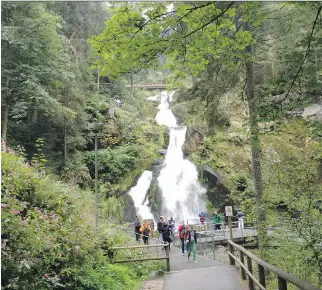  ?? PHOTOS: SIOBHAN STARRS/THE ASSOCIATED PRESS ?? People walking near a waterfall in Triberg, Germany. The historical Black Forest got its name from a canopy of leaves so dense that it left many parts of the woods in the dark even during daylight. It also inspired Grimm Brothers’ fairy tales.