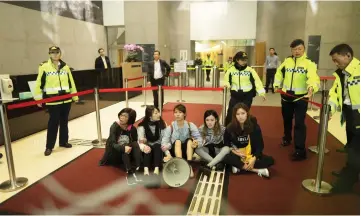  ?? — Reuters photo ?? Protesters from Demosisto and Lingnan University aresurroun­ded by security after storming Hong Kong government headquarte­rs over proposal to extradite fugitives to mainland China, in Hong Kong, China.