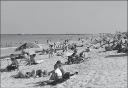  ?? CLIFF HAWKINS/GETTY IMAGES ?? Beachgoers take advantage of the opening of South Beach on Wednesday in Miami Beach, Florida. Miami-Dade County and the City of Miami opened their beaches as the area eases restrictio­ns put in place to contain COVID-19.