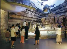  ?? PHOTOS PROVIDED TO CHINA DAILY ?? Right: Tourists seem to step back in time at the Geological Museum of Guizhou.