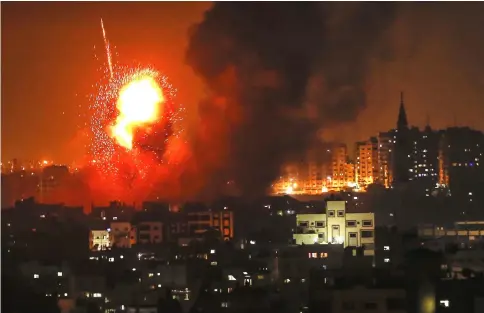  ?? — AFP photo ?? A fireball exploding during Israeli air strikes in Gaza City.