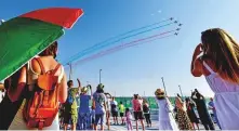  ?? Ahmed Ramzan/ Gulf News ?? Visitors enjoy an aerobatic display by the Red Arrows team of the Royal Air Force.