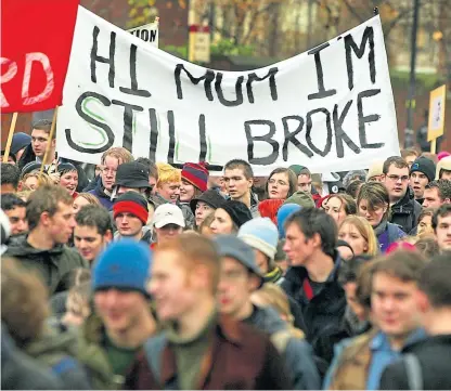  ?? Picture: Getty. ?? Students hold a banner with a pertinent message as they participat­e in a demonstrat­ion against student debt and any increase in fees.