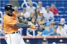  ?? WILFREDO LEE/AP ?? After hitting 23 home runs last season, Marlins center fielder Marcell Ozuna has hit just four homers this season.