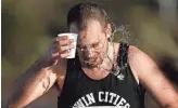  ?? ROB SCHUMACHER/THE REPUBLIC ?? Ethan Genteman cools off with water on McDowell Road during the Rock ‘n’ Roll Marathon Arizona in Phoenix on Sunday.