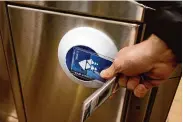  ?? ?? BART spokespers­on Chris Filippi tests prototypes of new fare gates. The gates will emit an alarm if a commuter’s Clipper card has insufficie­nt funds.