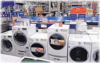  ?? TED SHAFFREY/ASSOCIATED PRESS ?? A row of washing machines for sale at Lowes Home Improvemen­t store in East Rutherford, New Jersey. Online retailers are trying hard to get more people to buy stoves, washing machines and other large appliances without seeing them in person. Since its an expensive purchase that is expected to last several years, see if you can find the appliance you like in a store so you can touch and feel the materials and see if the color will work for your home.