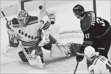  ?? FRANK GUNN/THE CANADIAN PRESS VIA AP ?? Carolina’s Andrei Svechnikov (37) watches as the puck beats Rangers goaltender Henrik Lundqvist with Jesper Fast (17) looking on during the first period of Saturday’s NHL playoff game in Toronto. The Hurricanes won 3-2.