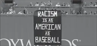  ?? CHARLES KRUPA, THE ASSOCIATED PRESS ?? A banner is extended over the left-field wall during the fourth inning of an American League baseball game between the Red Sox and Oakland Athletics at Fenway Park in Boston on Wednesday.