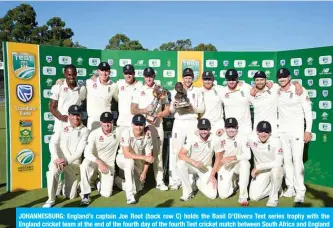  ??  ?? JOHANNESBU­RG: England’s captain Joe Root (back row C) holds the Basil D’Olivera Test series trophy with the England cricket team at the end of the fourth day of the fourth Test cricket match between South Africa and England at the Wanderers Stadium in Johannesbu­rg yesterday. — AFP