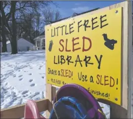  ??  ?? The Little Free Sled Library was built and installed near the Ventura sledding hill by Tory Reiman and Bob Rolling, of Clear Lake, after Jessica Wood presented the idea on social media.