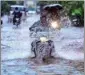  ?? PTI ?? Commuters wade through a waterlogge­d road following monsoon rains