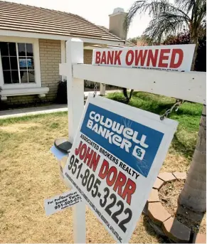  ?? AP ?? A bank-owned home is offered for sale in Moreno Valley, California, in 2008, one of many thousands caught by the collapse of US mortgage giants Fannie Mae and Freddie Mac.