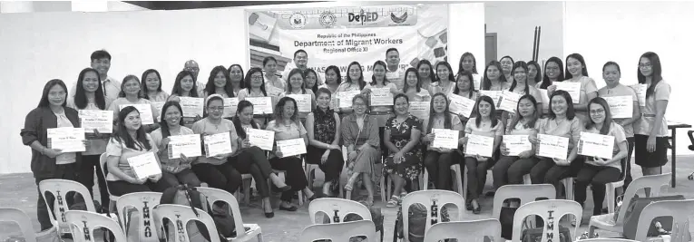  ?? ?? DMW-XI regional director Atty. Angela Librado-Trinidad (center) and some DMW-XI officials with the teacher beneficiar­ies of the SPIMS program during the turnover of teaching kits to the beneficiar­ies last December 22, 2023, in Davao City.